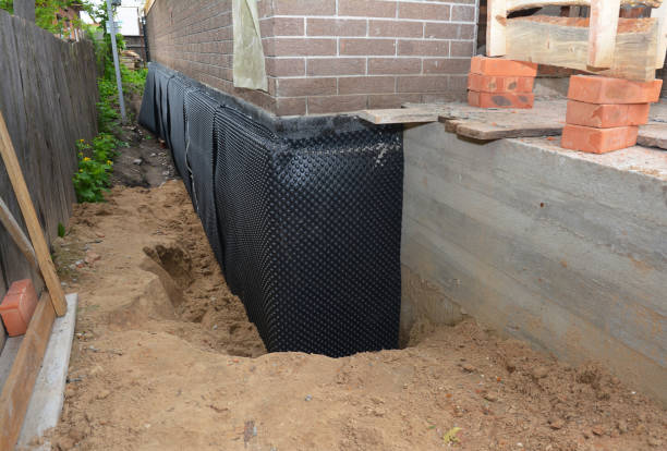 Happy homeowners after waterproofing job in Byers